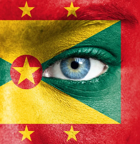 Menselijk gezicht beschilderd met vlag van grenada — Stockfoto