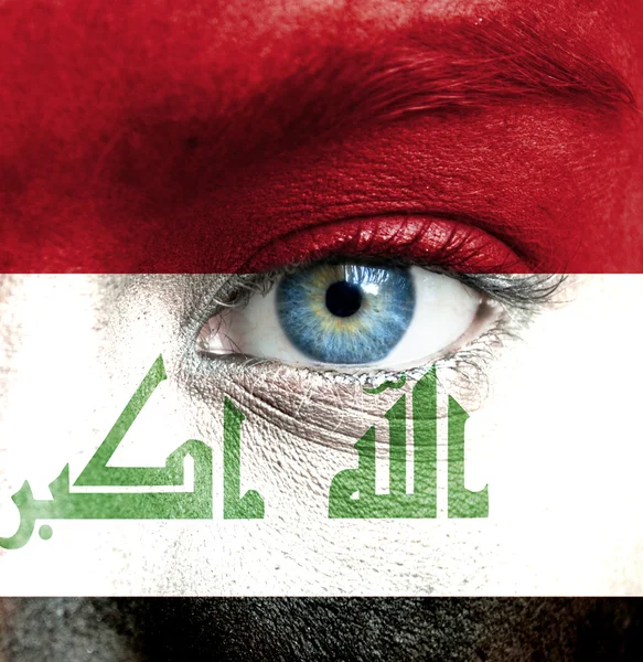 Human face painted with flag of Iraq — Stock Photo, Image