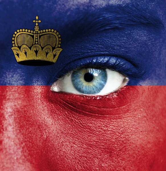 Human face painted with flag of Liechtenstein — Stock Photo, Image