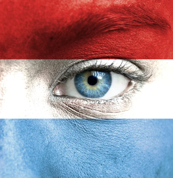 Menschengesicht mit luxemburgischer Flagge bemalt — Stockfoto