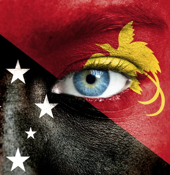 Human face painted with flag of Papua New Guinea — Stock Photo, Image