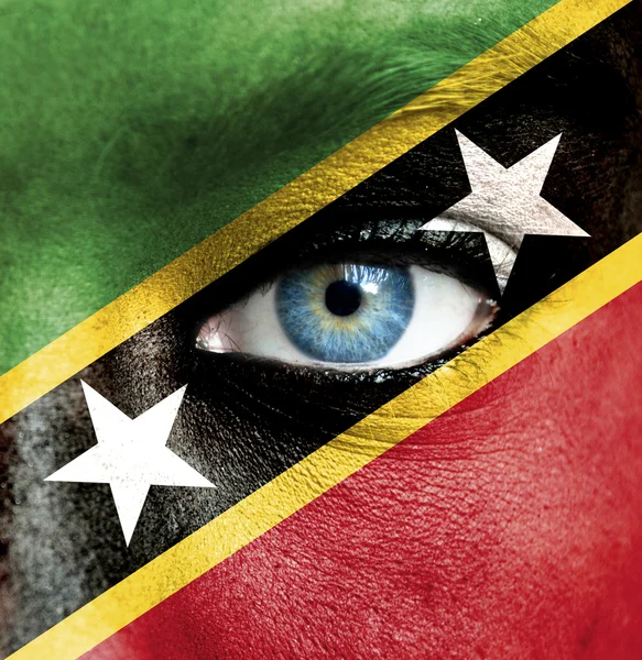 Human face painted with flag of Saint Kitts and Nevis — Stock Photo, Image