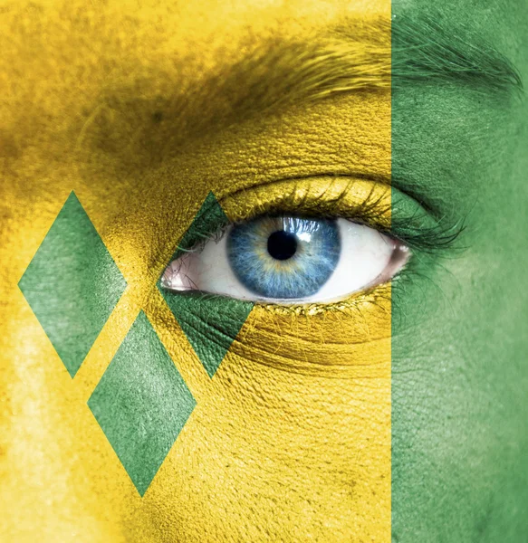 Human face painted with flag of Saint Vincent and the Grenadines — Stock Photo, Image