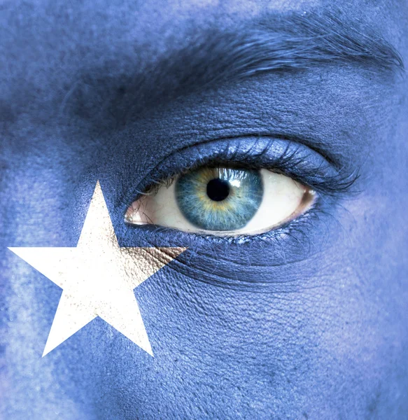 Human face painted with flag of Somalia — Stock Photo, Image