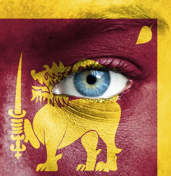 Human face painted with flag of Sri Lanka — Stock Photo, Image