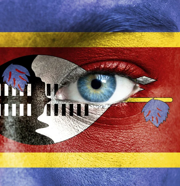 Human face painted with flag of Swaziland — Stock Photo, Image