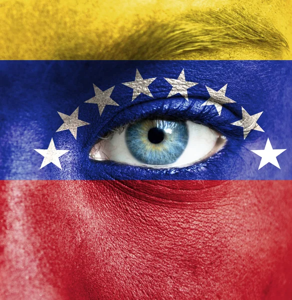 Human face painted with flag of Venezuela — Stock Photo, Image