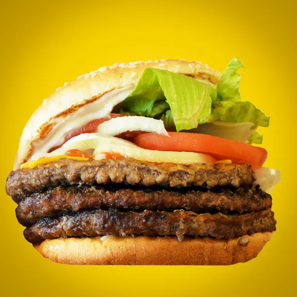 Hamburger against yellow background — Stock Photo, Image