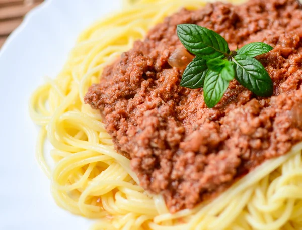 Spaghetti bolognese on white plate macro shot — Stock Photo, Image