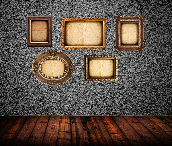 Empty room interior with black wall and vintage photo frames — Stock Photo, Image