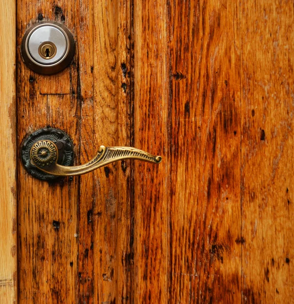 Old wooden door with hande and lock close up — Stock Photo, Image