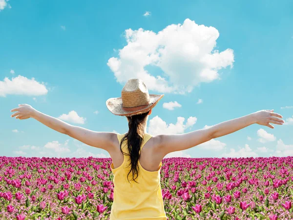 Chica extendiendo sus brazos en el medio del campo de tulipanes - Disfrute de nat — Foto de Stock