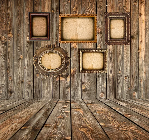 Grunge room with empty photo frames — Stock Photo, Image