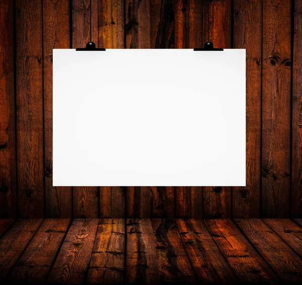 Blank paper board hanging on wooden wall — Stock Photo, Image