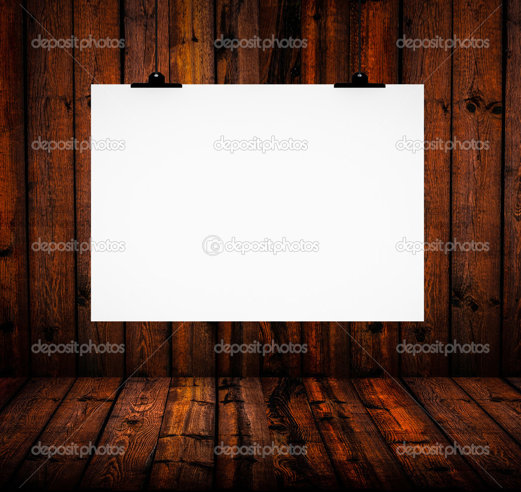 Blank paper board hanging on wooden wall