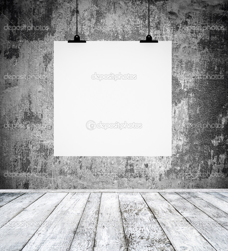 Empty room with blank paper board hanging on a wall