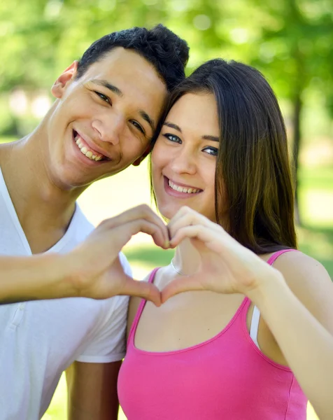 Couple making heart with hands outdoor — Stock Photo, Image