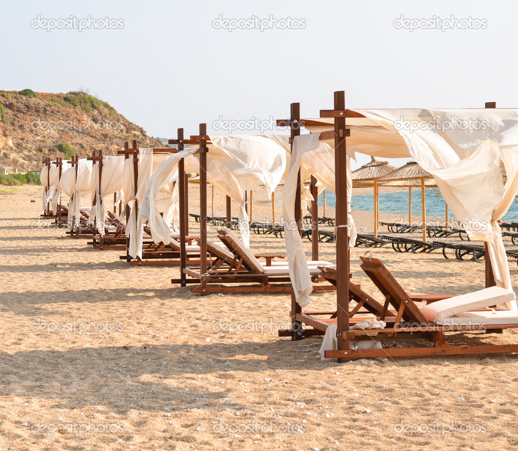 Row of luxurious beds on beach resort