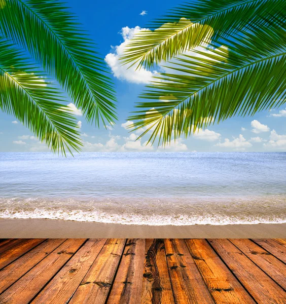 Mare tropicale e spiaggia con foglie di palma e pavimento in legno — Foto Stock
