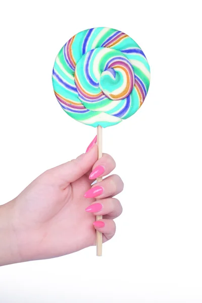 Hand holding giant colorful lollipop isolated on white — Stock Photo, Image