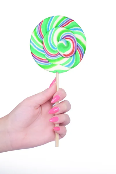 Hand holding giant colorful lollipop isolated on white — Stock Photo, Image