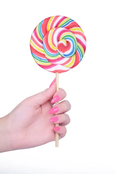 Hand som håller jätte färgglada lollipop isolerad på vit — Stockfoto