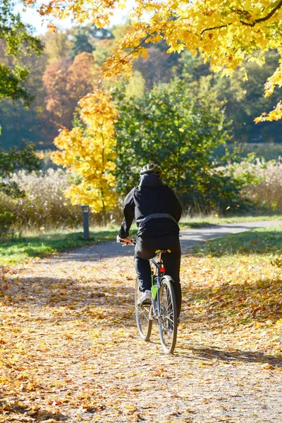 Biker driving at park in Autumn — Stock Photo, Image