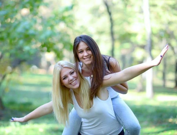 Two happy girls playing around in park — Stock Photo, Image