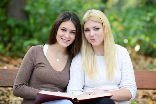 Dos chicas leyendo libro en el parque — Foto de Stock