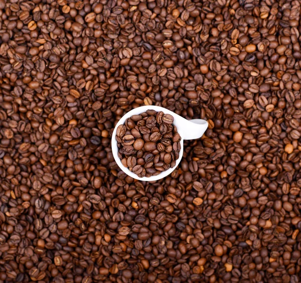 Cup of coffee filled with coffee beans abstract view — Stock Photo, Image