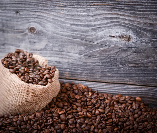 Sack of fresh coffee beans with smoke — Stock Photo, Image