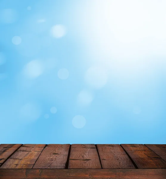 Blauwe lichte bokeh en zonlicht tegen houten vloer - natuur bac — Stockfoto