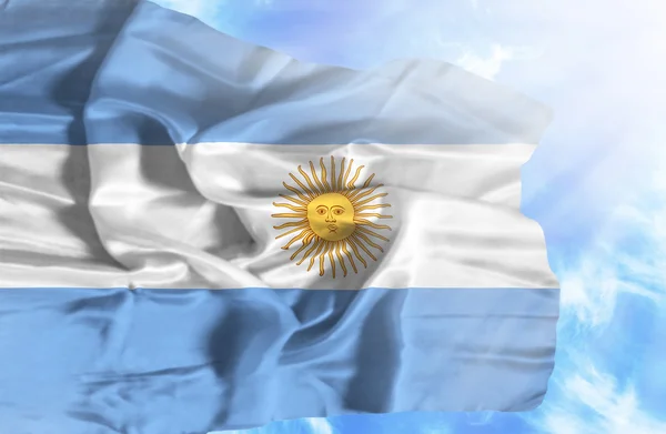 Argentina waving flag against blue sky with sunrays — Stock Photo, Image