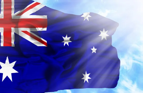 Australien schwenkt Flagge gegen blauen Himmel mit Sonnenstrahlen — Stockfoto