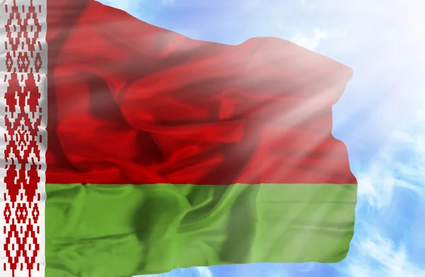 Belarus waving flag against blue sky with sunrays — Stock Photo, Image