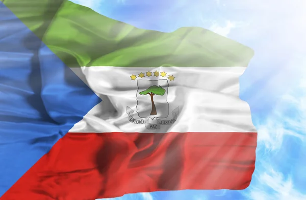 Equatorial Guinea waving flag against blue sky with sunrays — Stock Photo, Image