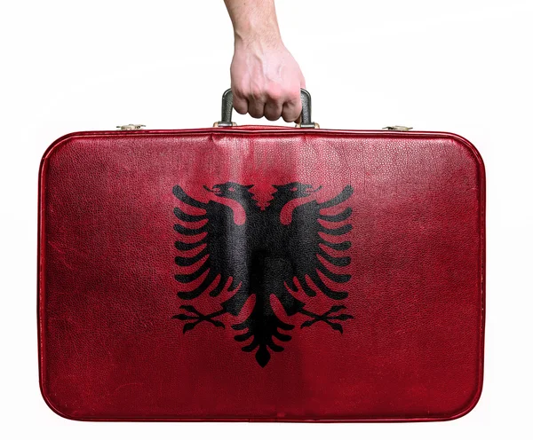 Tourist hand holding vintage leather travel bag with flag of Alb — Stock Photo, Image