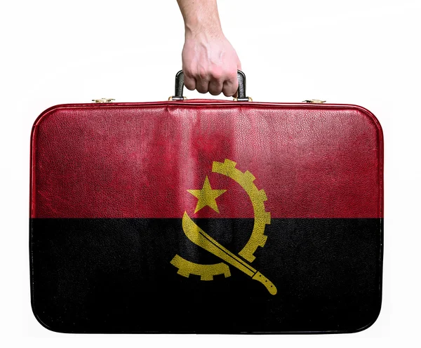 Tourist hand holding vintage leather travel bag with flag of Ang — Stock Photo, Image