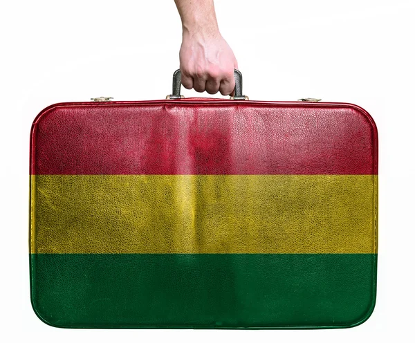 Tourist hand holding vintage leather travel bag with flag of Bol — Stock Photo, Image