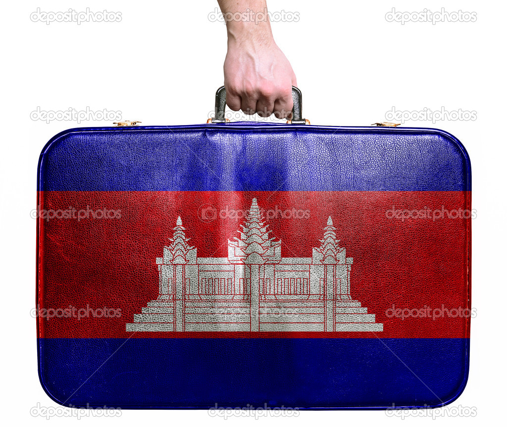 Tourist hand holding vintage leather travel bag with flag of Cam