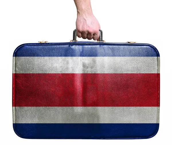 Mão turística segurando saco de viagem de couro vintage com bandeira de Cos — Fotografia de Stock