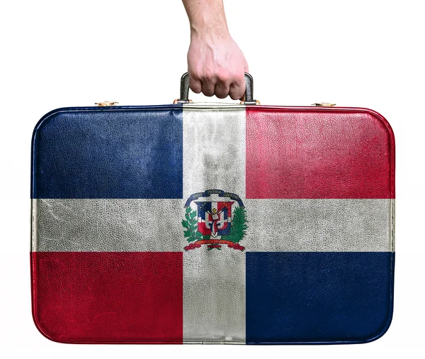 Tourist hand holding vintage leather travel bag with flag of Dom — Stock Photo, Image