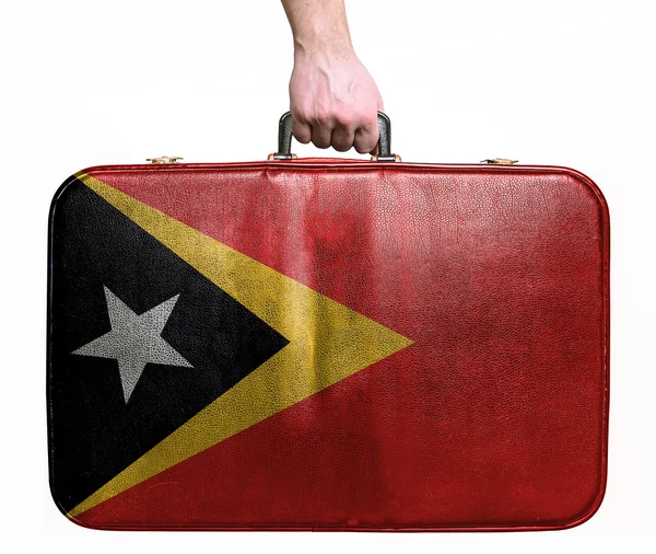 Turistik el Vintage deri seyahat çantası eas bayrağı ile tutarak — Stok fotoğraf