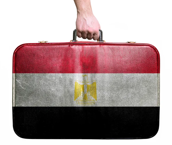 Tourist hand holding vintage leather travel bag with flag of Egy — Stock Photo, Image