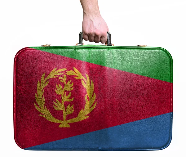 Tourist hand holding vintage leather travel bag with flag of Eri — Stock Photo, Image