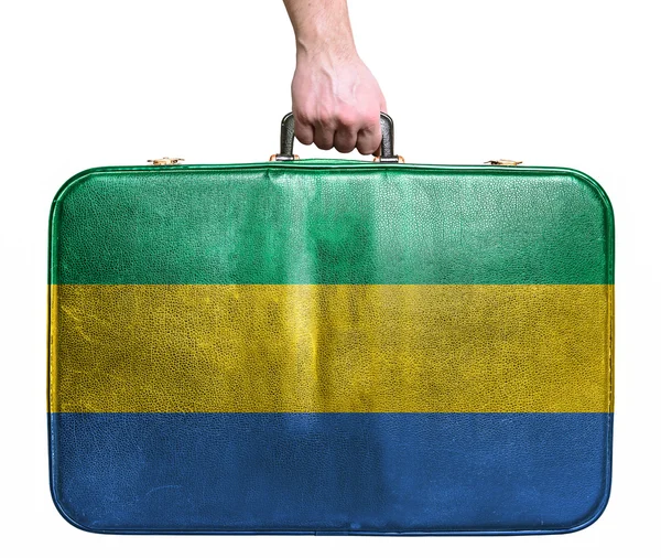 Tourist hand holding vintage leather travel bag with flag of Gab — Stock Photo, Image