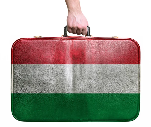 Tourist hand holding vintage leather travel bag with flag of Hun — Stock Photo, Image