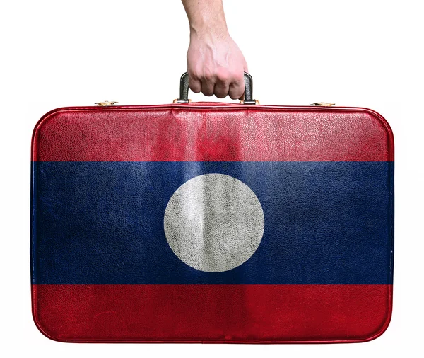 Turistické ruka drží ročník kožená cestovní taška s příznakem lao — Stock fotografie