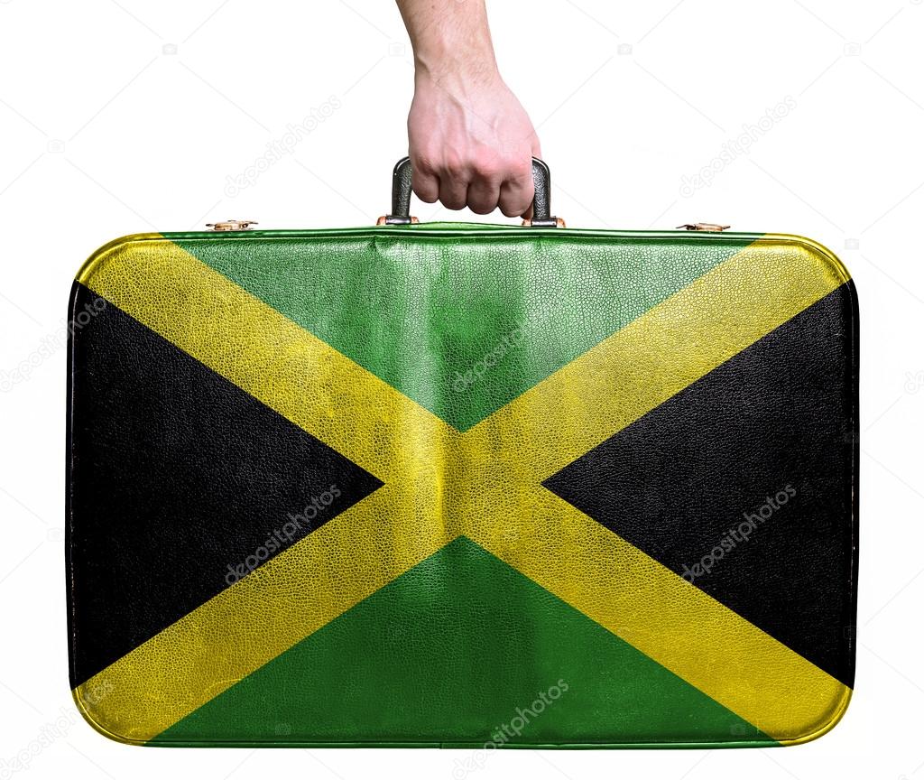 Tourist hand holding vintage leather travel bag with flag of Jam