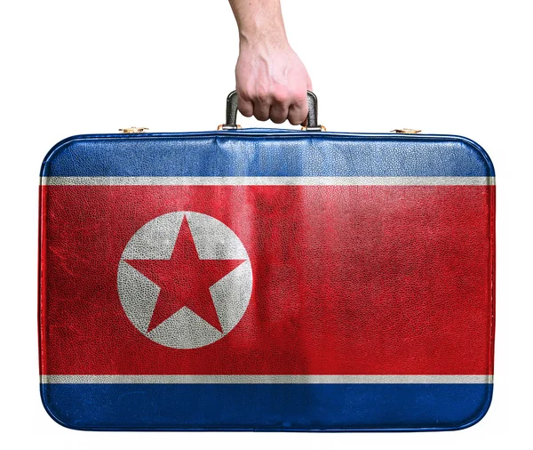 Tourist hand holding vintage leather travel bag with flag of Nor — Stock Photo, Image